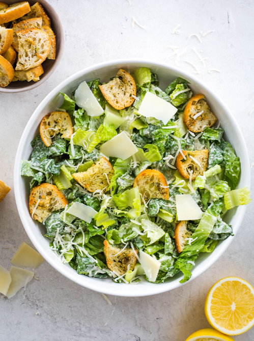 Caesar salad with romaine lettuce, croutons, parmesan cheese, and lemon slices