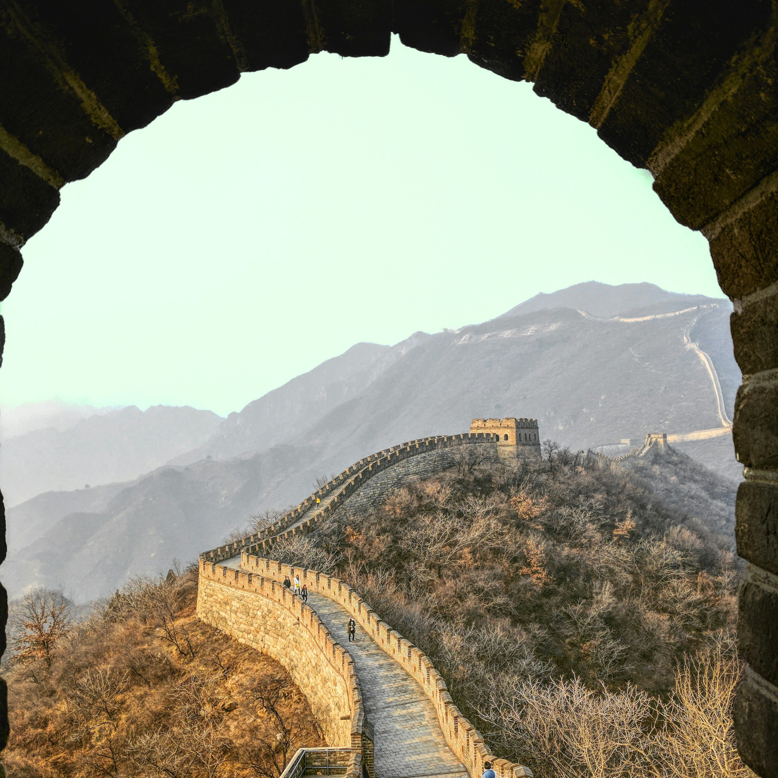 The Great Wall of China winding through mountain scenery.