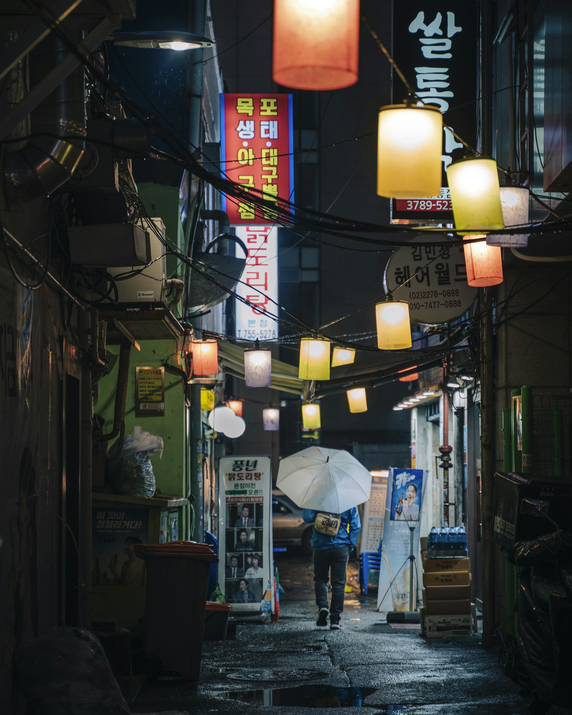 Lanterns illuminating a narrow alley at night.