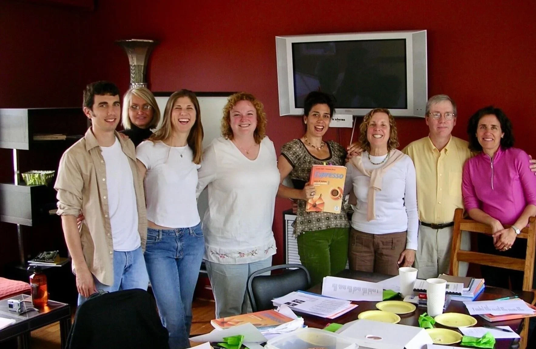 A group posing in a meeting room.