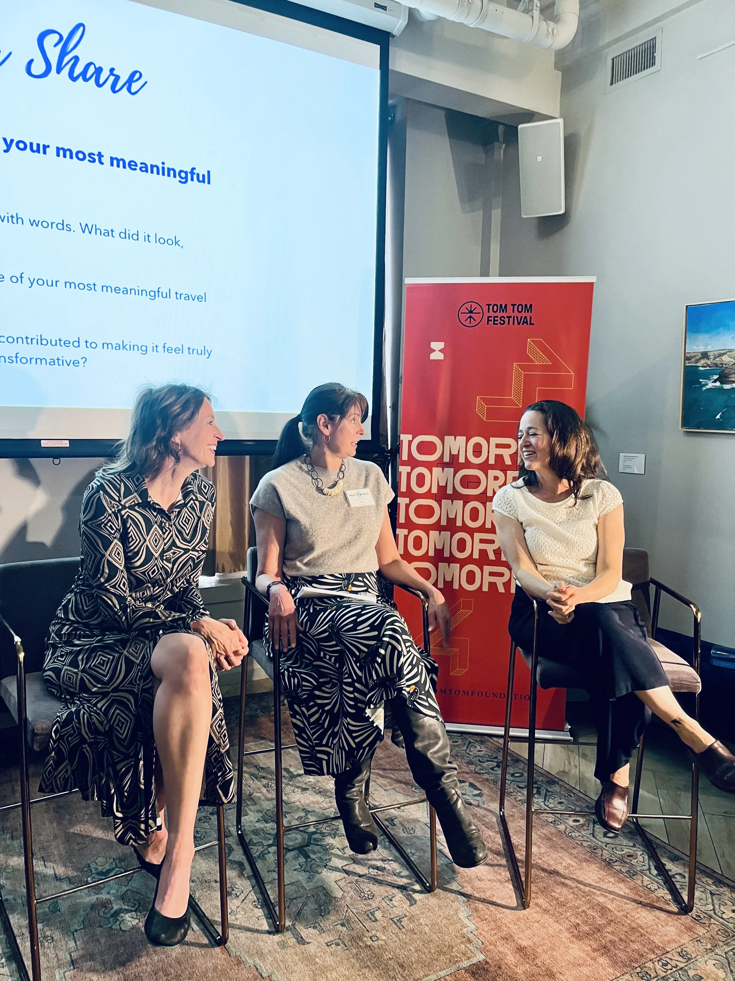 Three women taking part in a panel discussion.