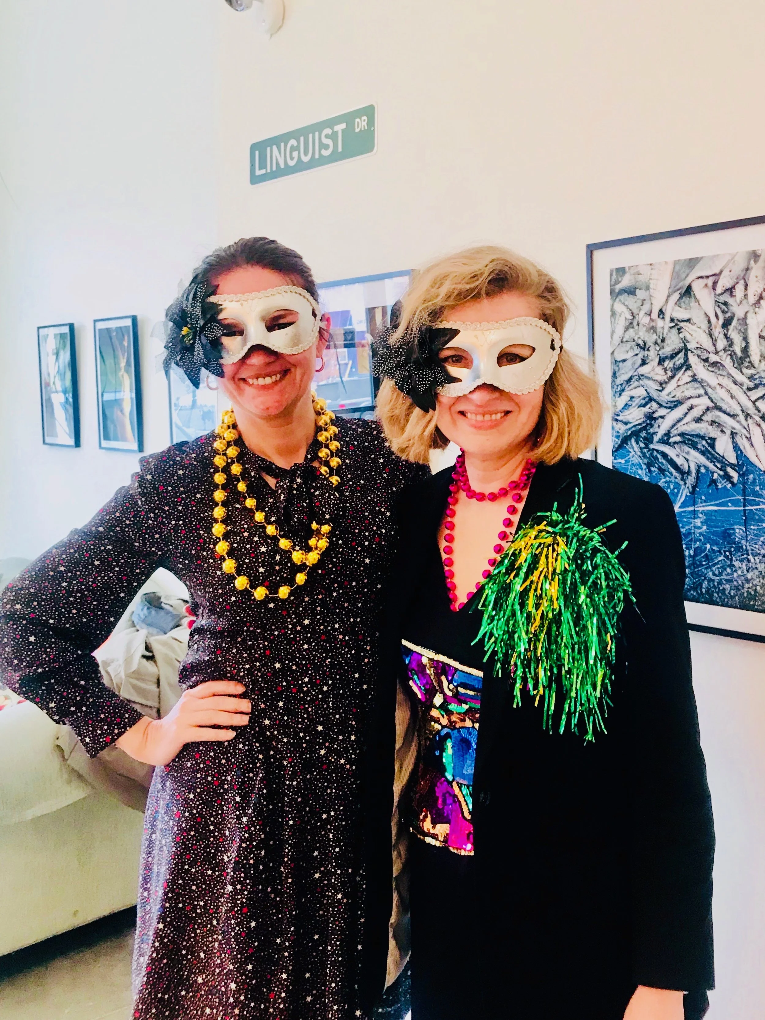 Two women wearing decorative masks.
