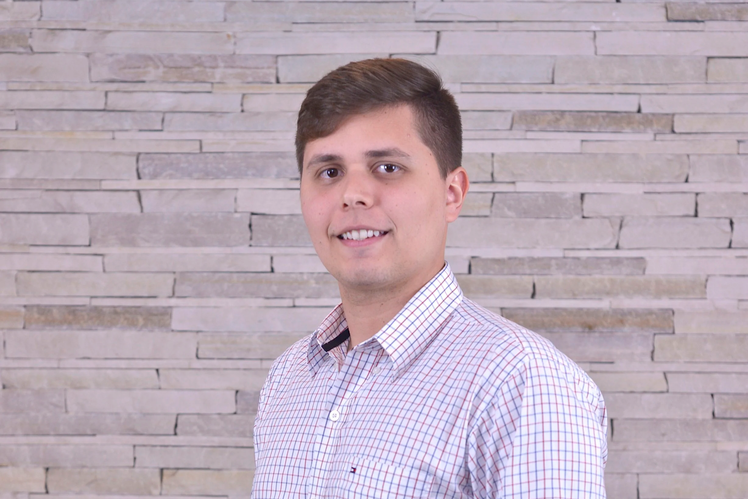 Portrait of a man wearing a checked shirt.