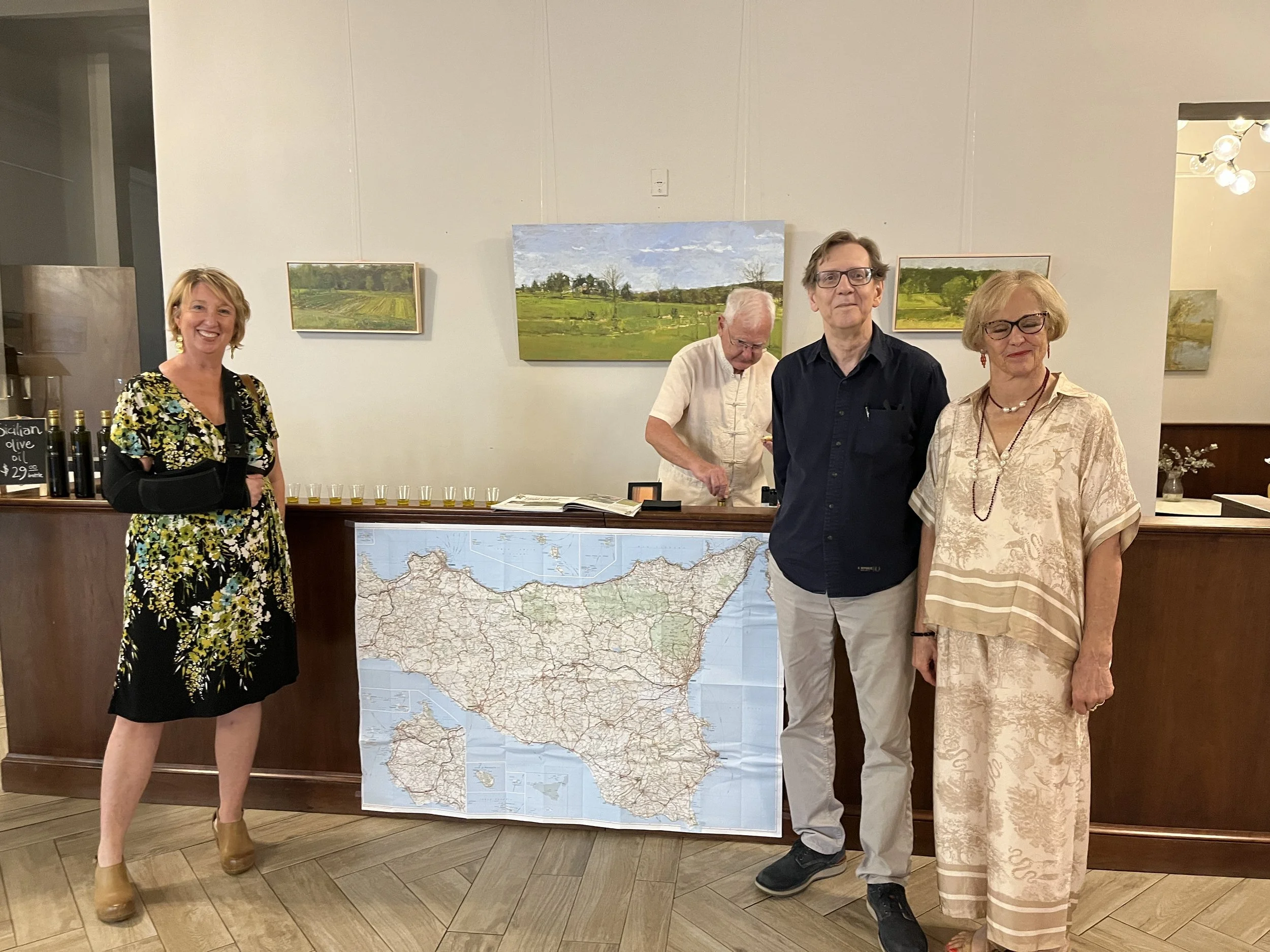 Four people posing behind a map of Ireland.