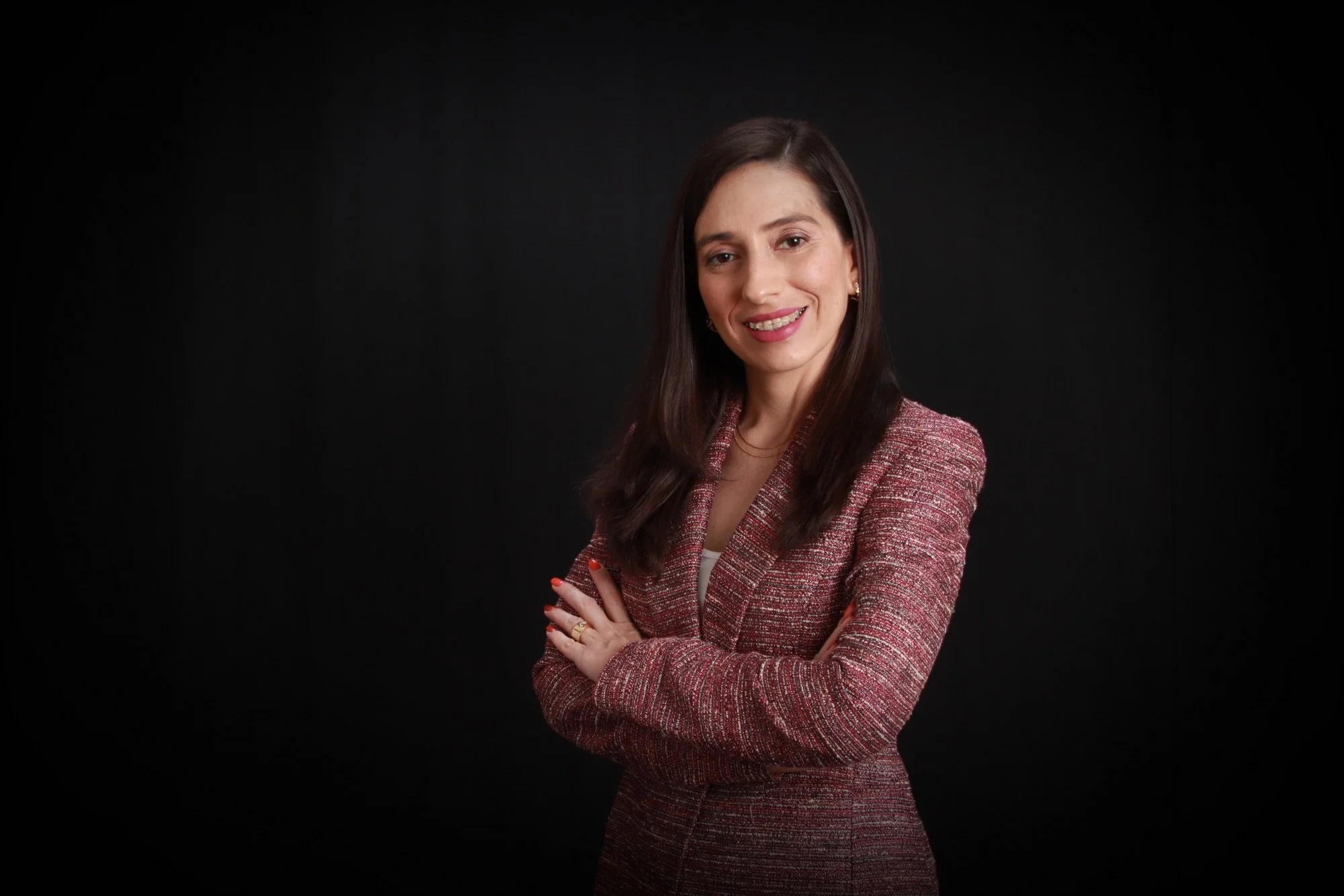 Portrait of a woman wearing a pink blazer.