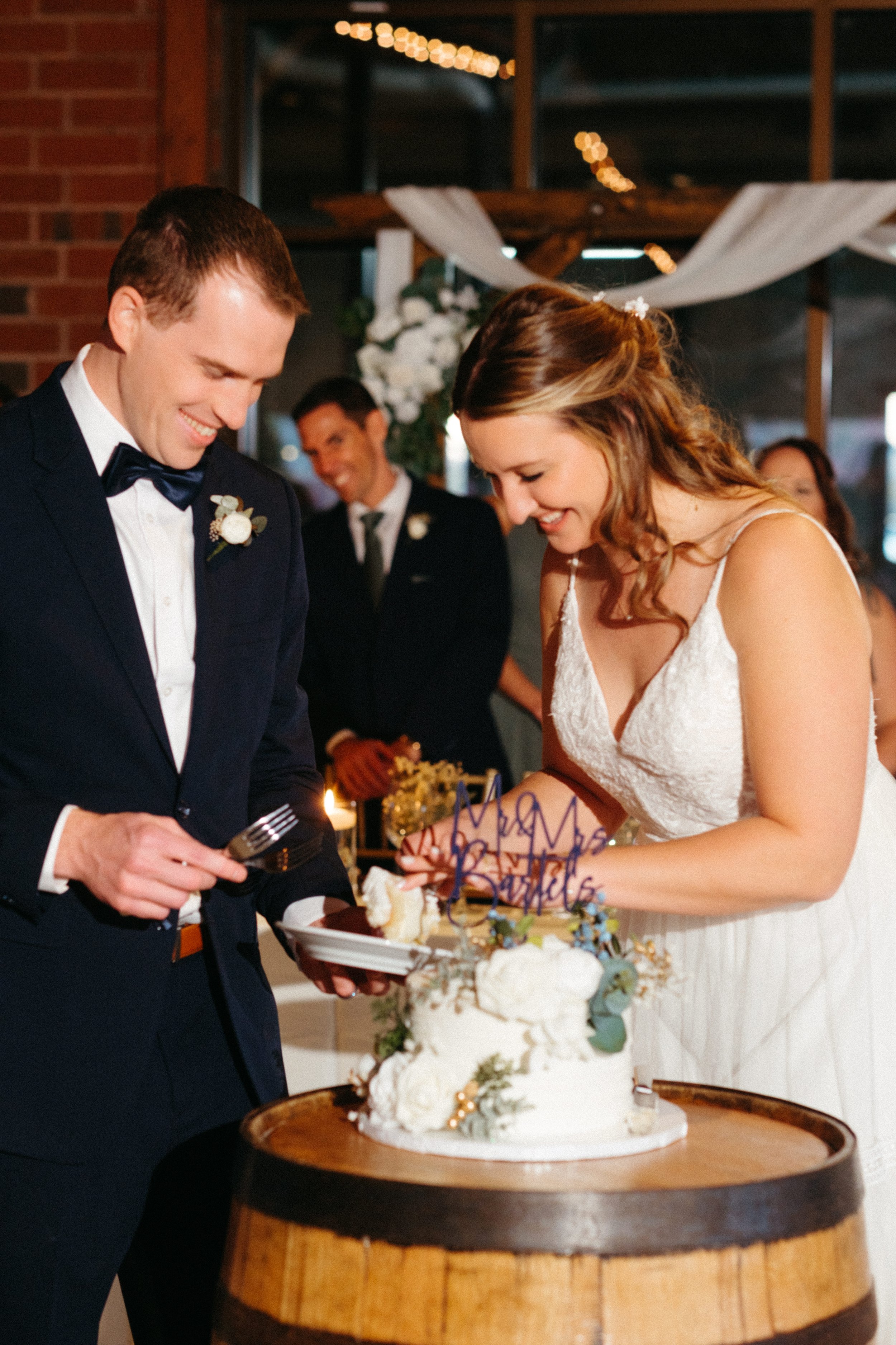 Laurie’s customers, Mariana and Carmen holding hands on a green lawn on their wedding day.