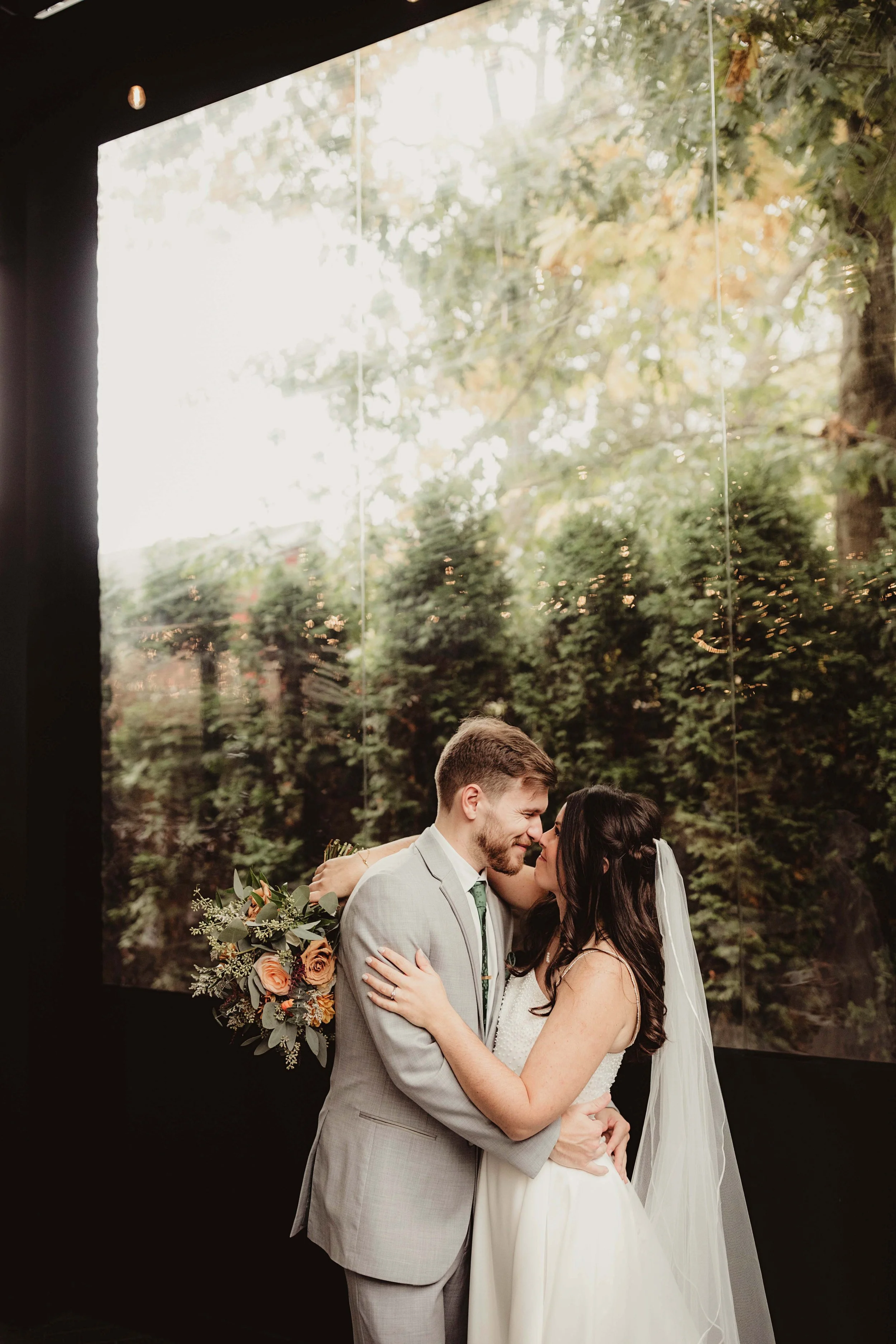 Laurie’s customers, Fernando and Kate embracing by the lake on their wedding day.