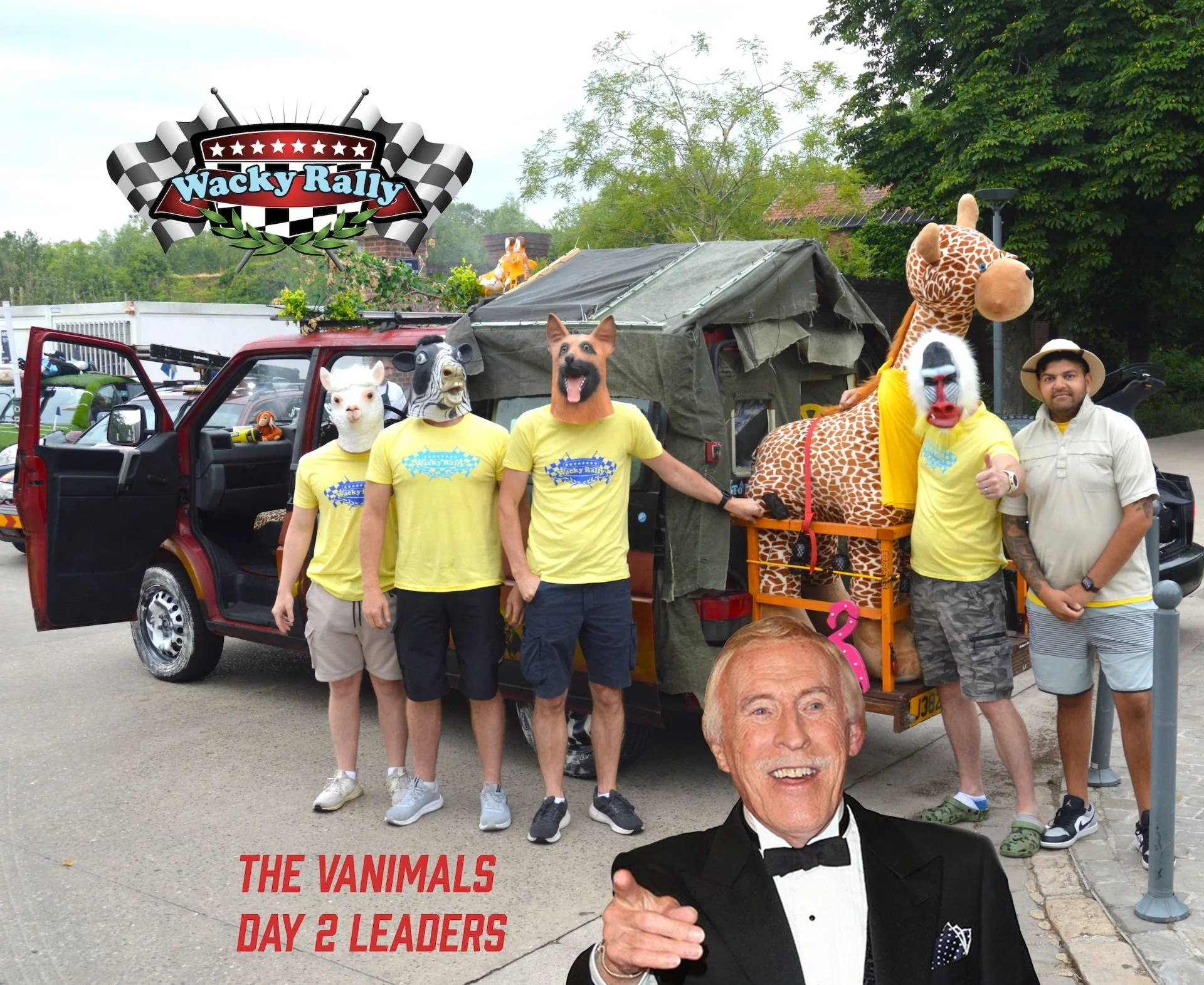 A group of people wearing Wacky Rally T-shirts with animal masks, including a llama, dog, zebra, giraffe, and a person in a mask. They are standing next to a vehicle decorated for a themed event, with a large cutout of Bob Barker in the foreground an