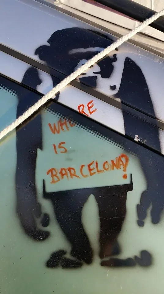 A sticker on a car window with the question, ''Where is Barcelona?'' written in red marker.