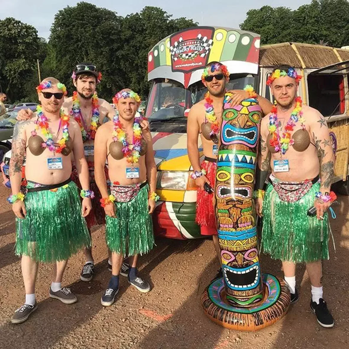 A Wacky Rally team of contestants dressed in hula skirts with coconut bra's and a tiki bus
