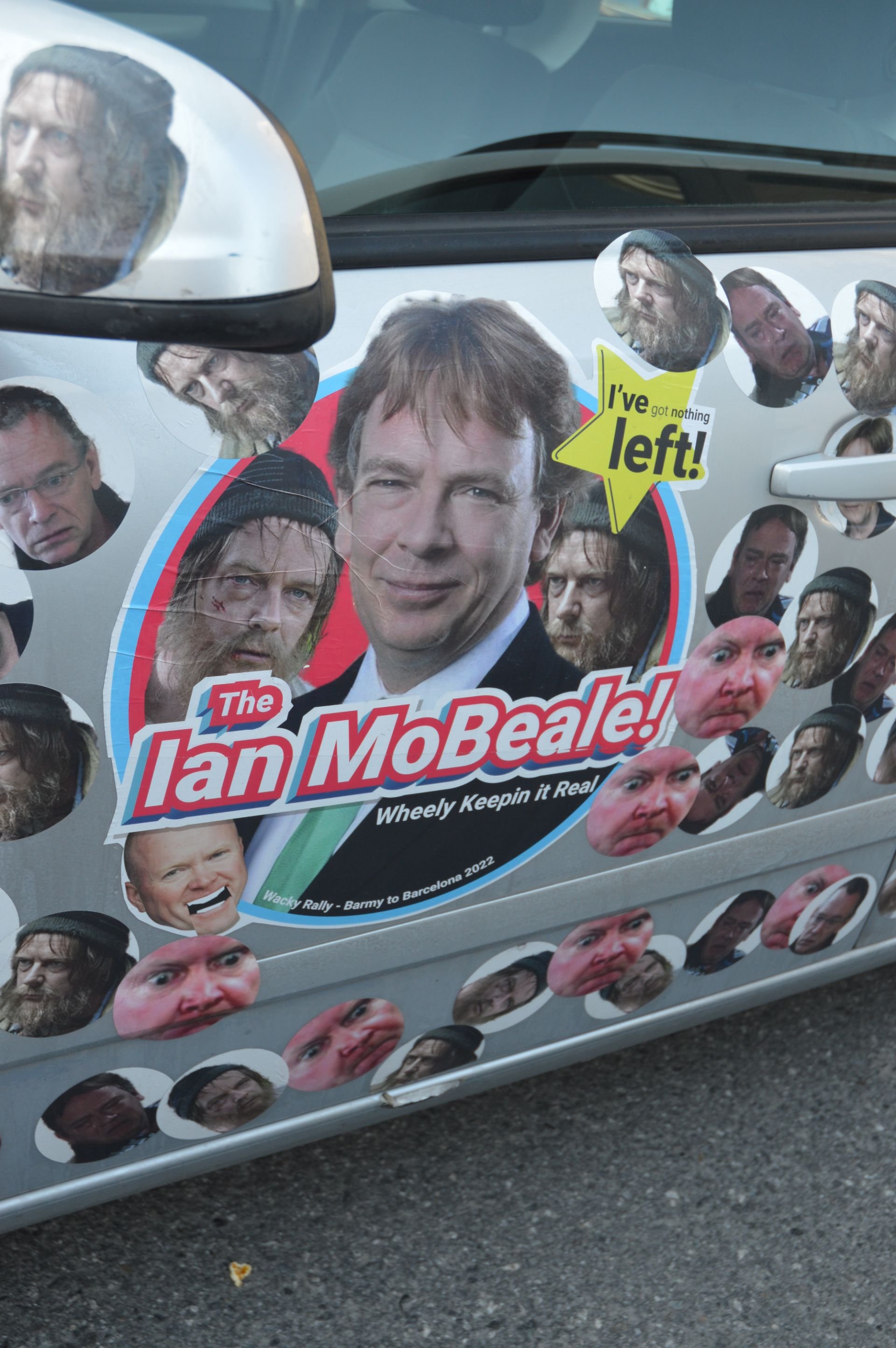 Car door decorated with stickers featuring the faces of Ian McBeale from the TV show, with many humorous, exaggerated face stickers surrounding the main image. Text includes "The Ian MoBeale!" and "I've got nothing left!"
