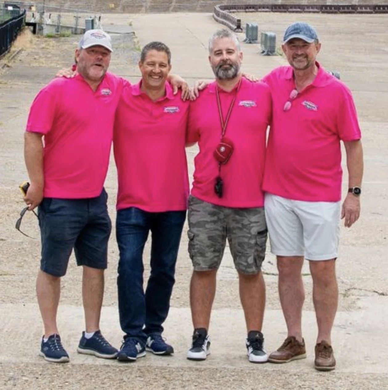 The Wacky Rally owners, smiling, wearing matching pink Wacky Rally shirts, with arms around each other.