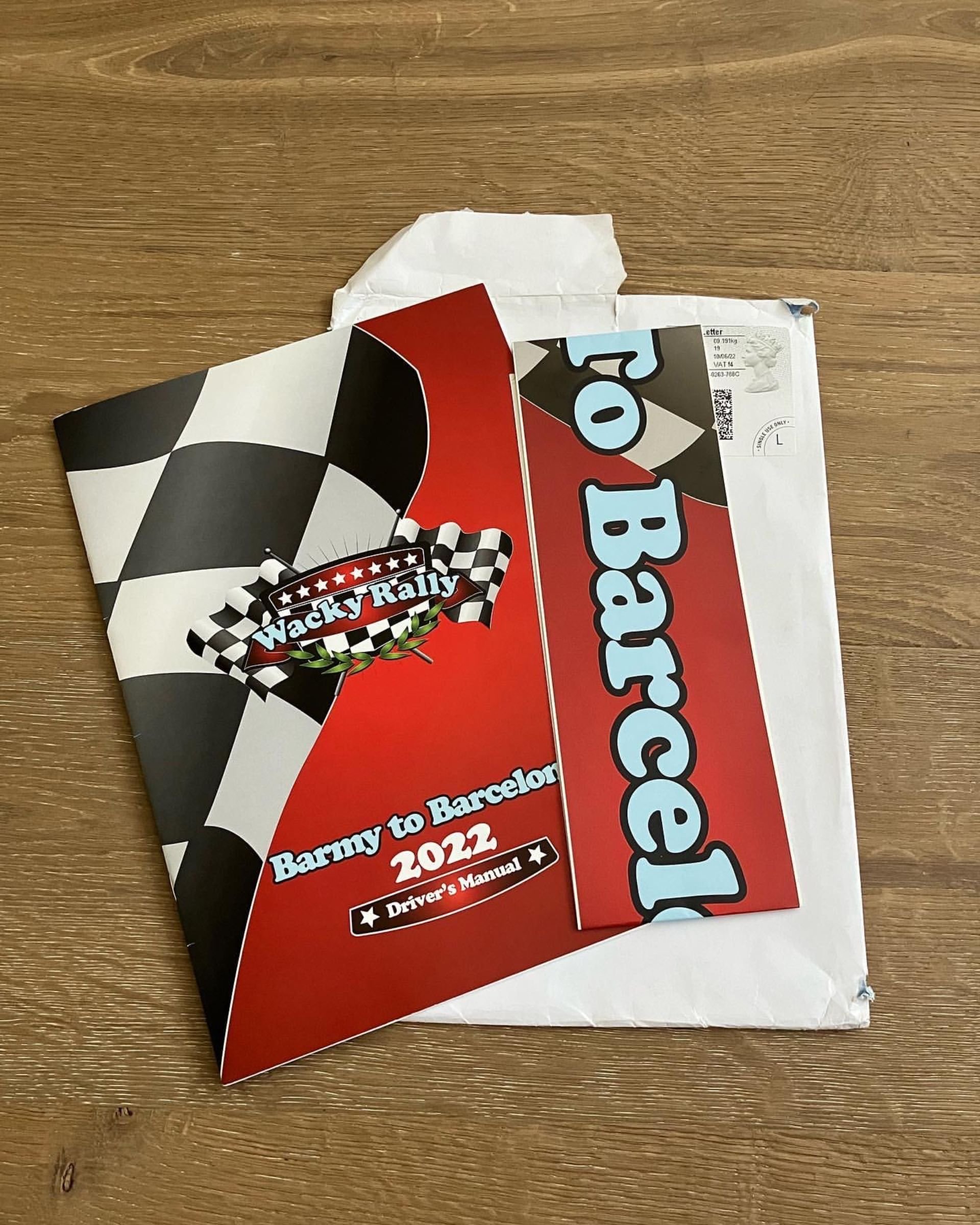 Race car driver’s manual and a cafe receipt on a wooden table