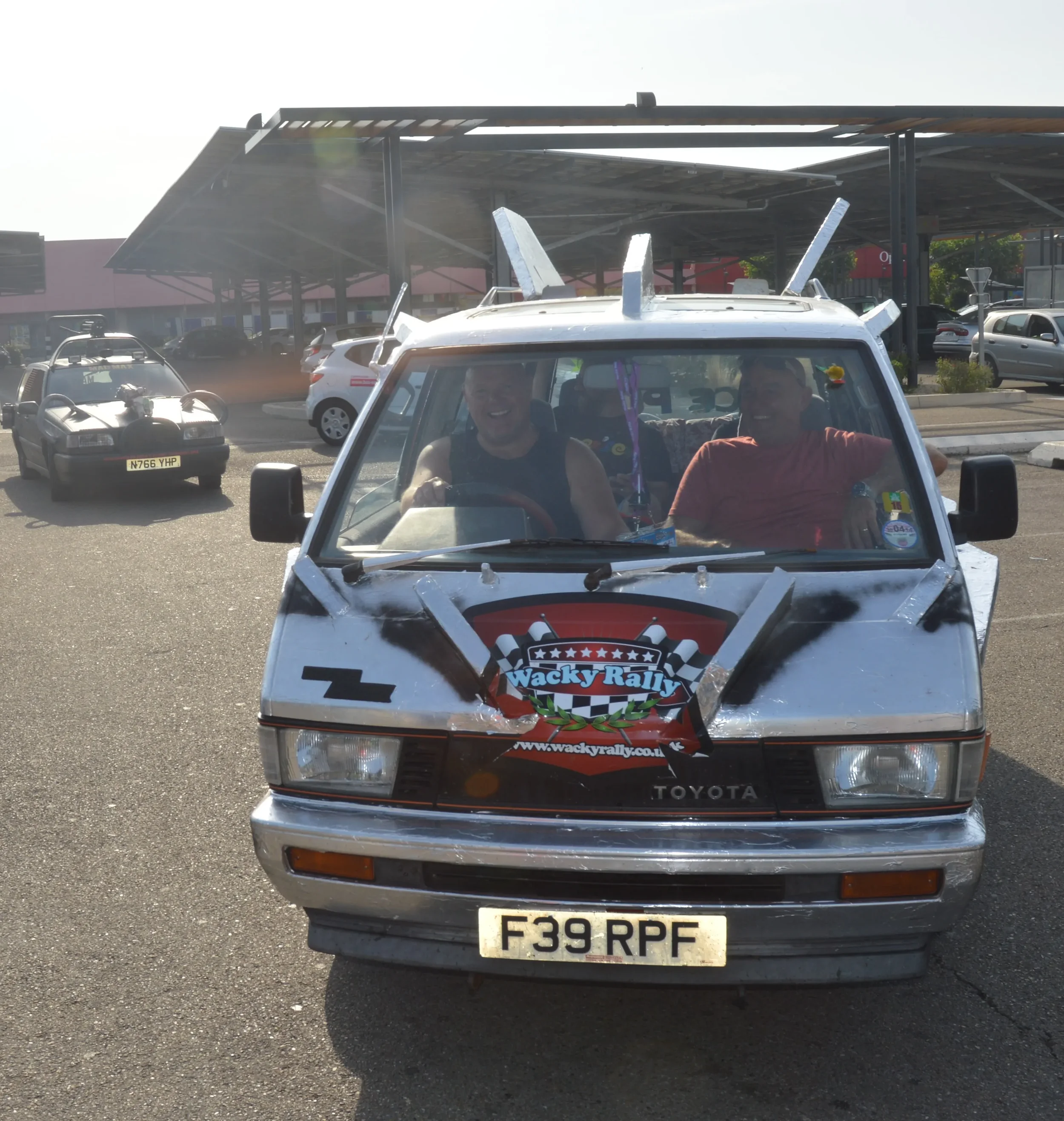 A modified Toyota van with racing decals and a 