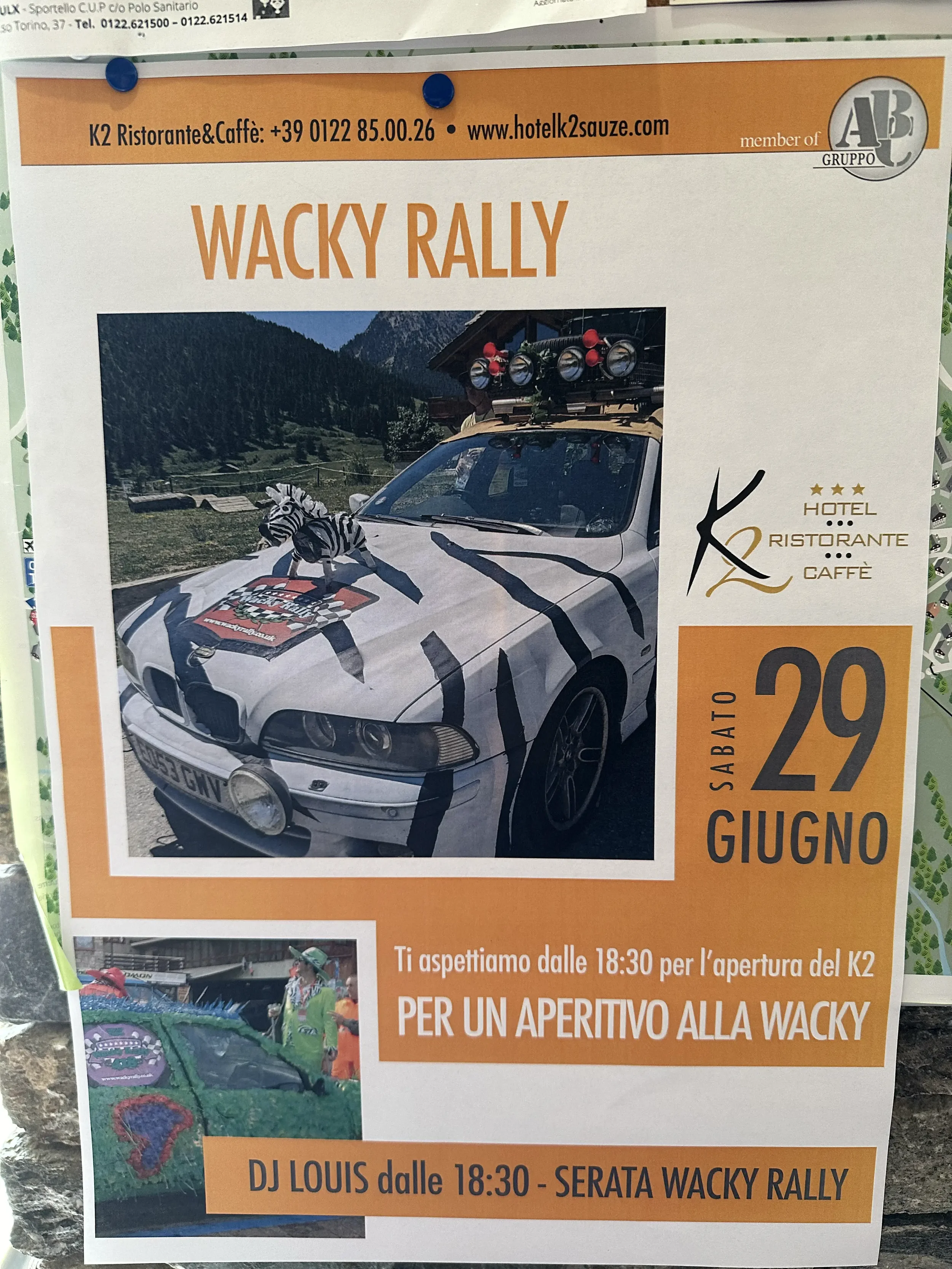Event poster for Wacky Rally featuring a car with zebra stripes, a zebra plush toy on the hood, and mountain scenery in the background. The event is scheduled for Saturday, June 29, with an opening at 6:30 PM, followed by a Wacky Rally celebration wi