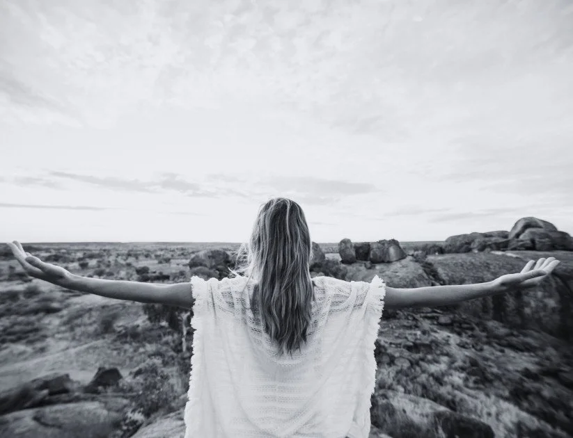 Woman in nature looking fulfilled
