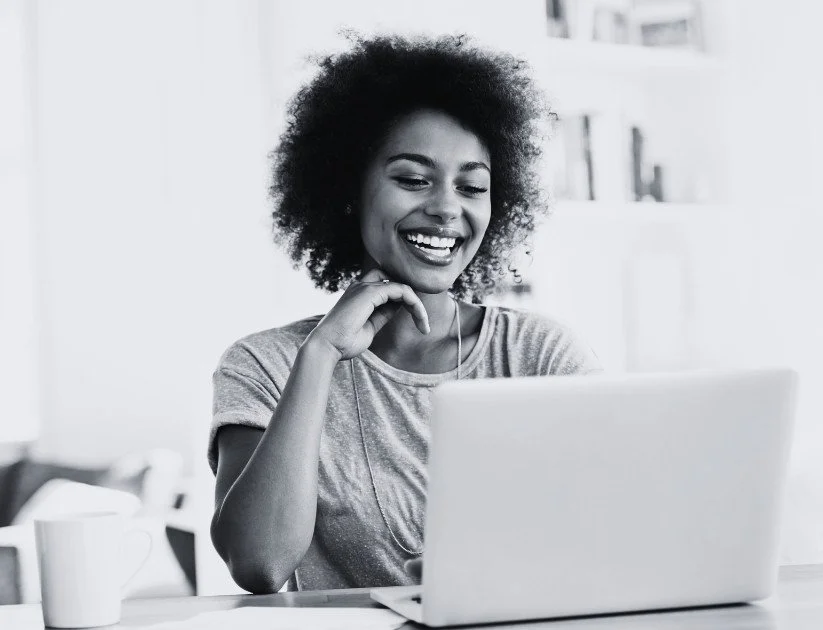 Women smiling at her laptop