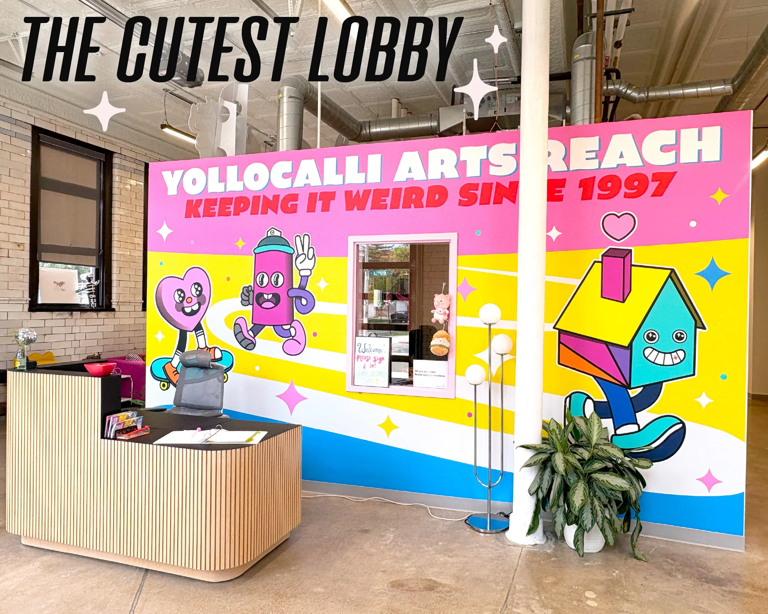 Graphic text reads, "The cutest lobby" over an image of an open concept lobby space. A wood panneled desk, plants, and a floor lamp are visible in front of colorful mural featuring illustrations of a house a spraypaint can and a heart.