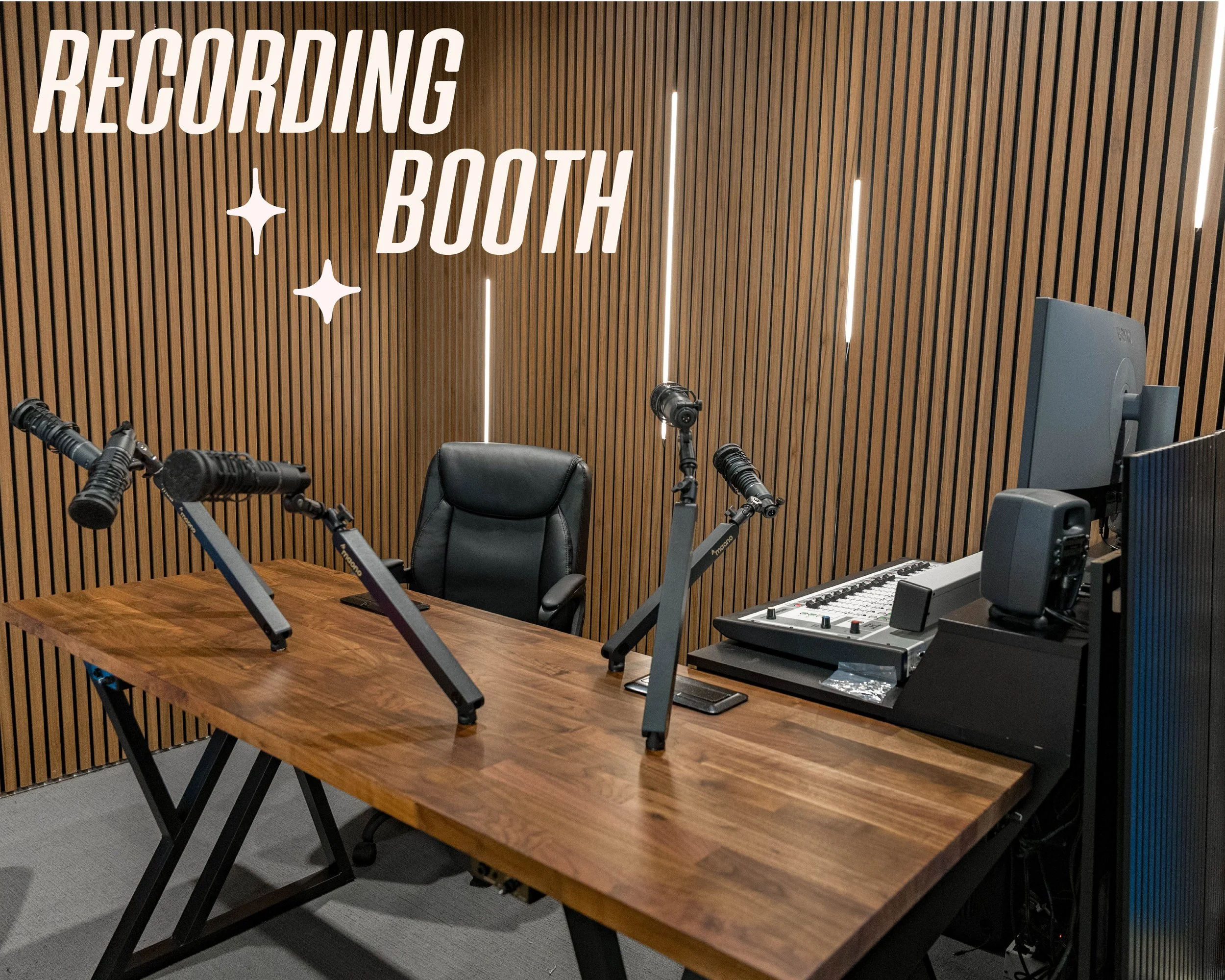 Graphic text reading "Recording Booth" sits over an image of a wood panneled room with LED lighting. A wooden table with attached audio mics, and a comfortable leather chair are in the foreground. A computer and audio recording equipment are visible.