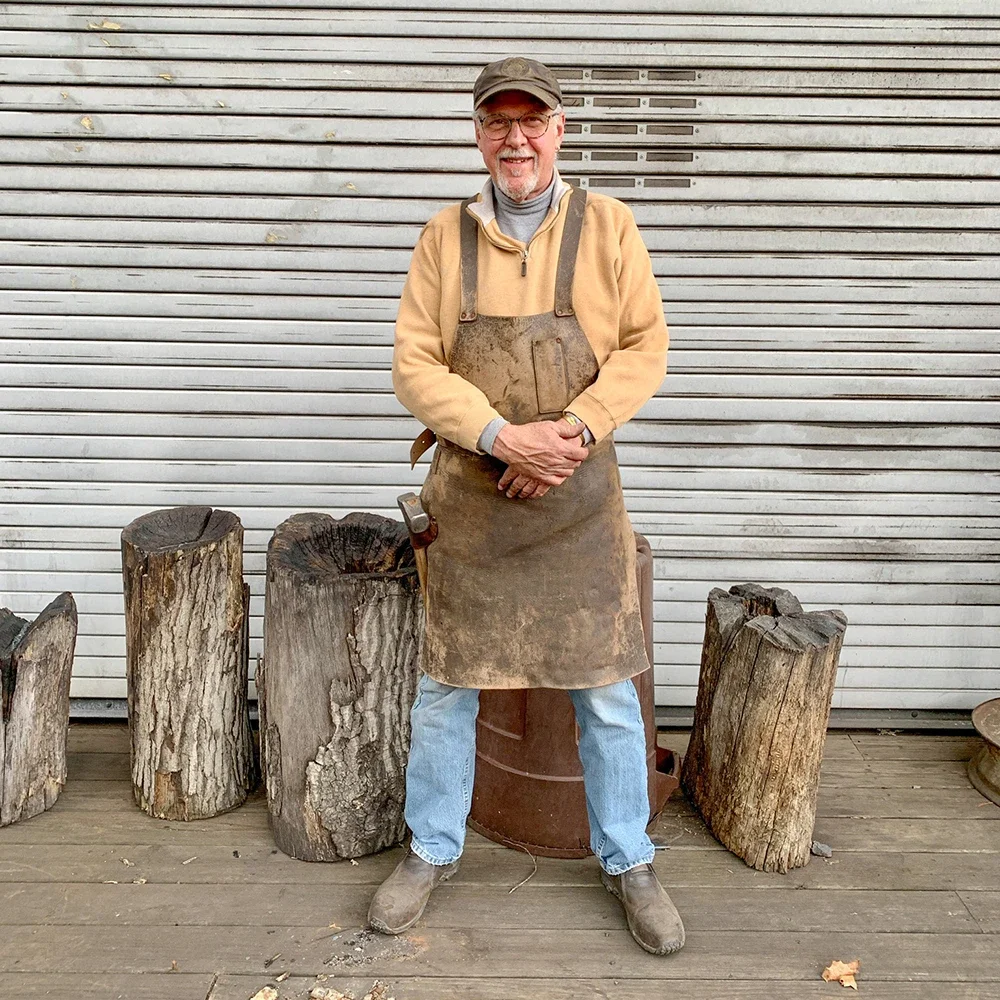 Adorable blacksmith James Cooper posing for a photo.