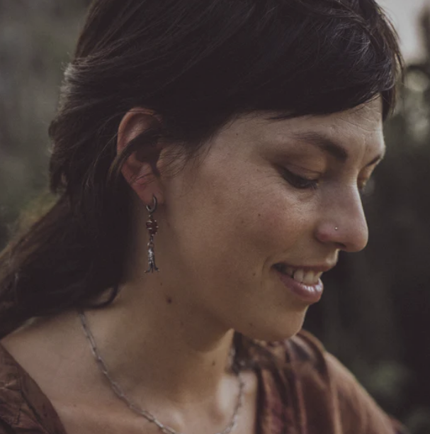 Jeweler Laura Lau Klein wearing handmade earrings and a necklace.