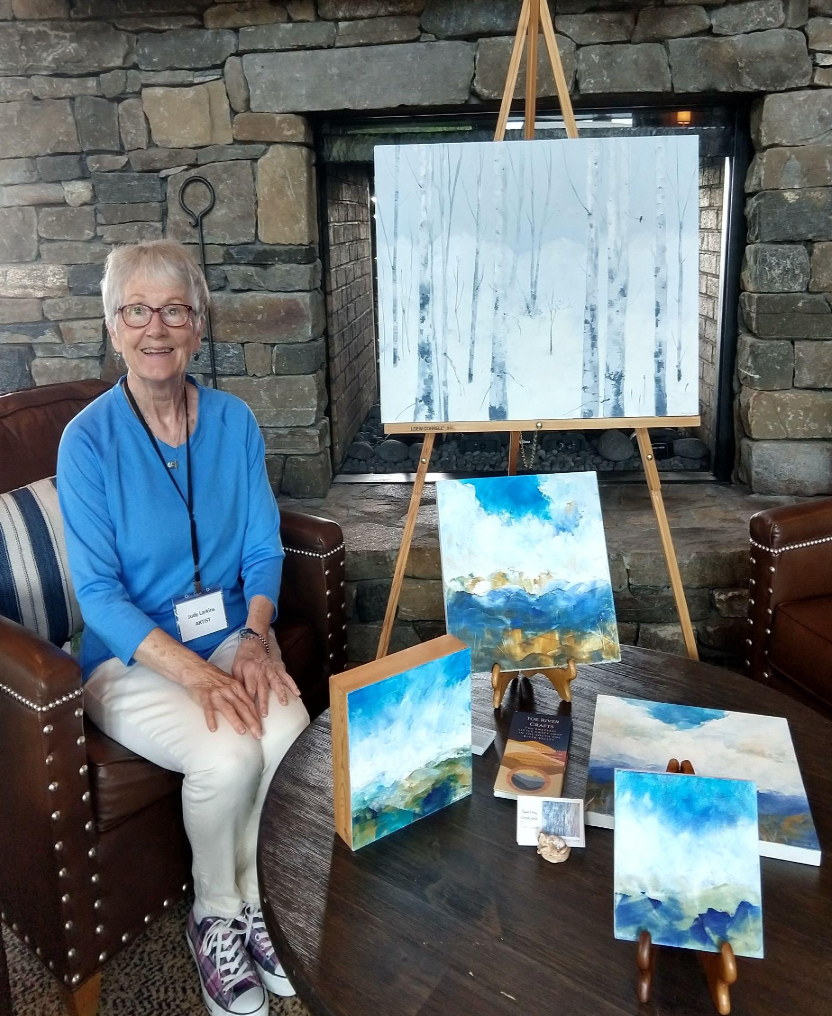Painter Judy Larkins amongst her paintings.