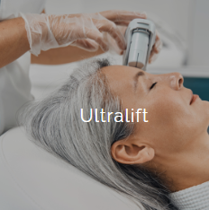Close-up of a woman receiving ultralift facial treatment with a handheld device from a skincare professional