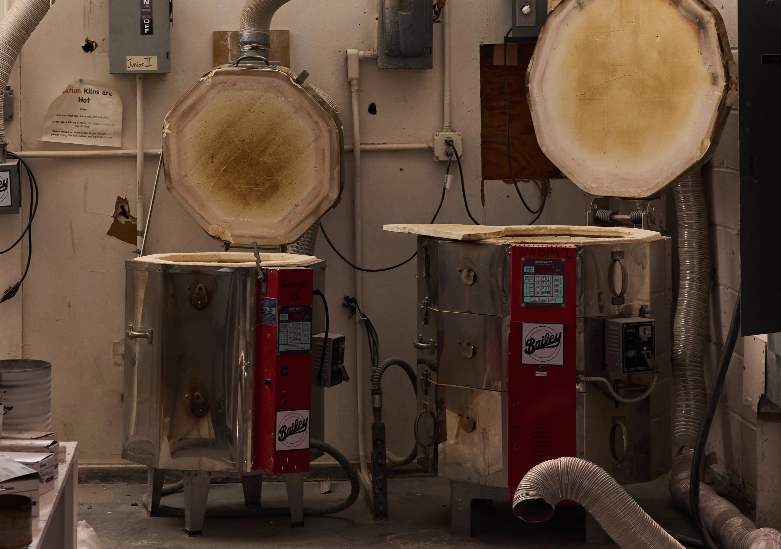 Two large, open kilns in a ceramics shop, representing hands-on making at Village of Industry & Art.