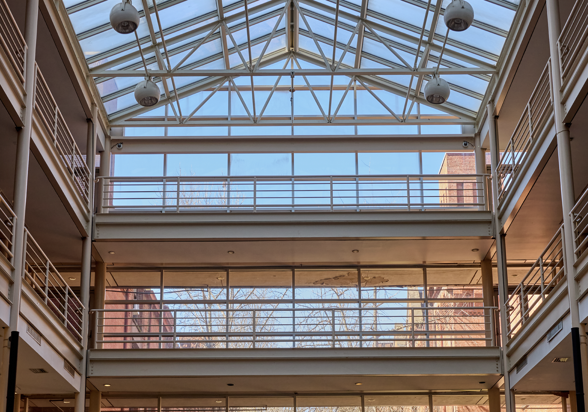 A upward view of the 4-story glass atrium from the floor inside.