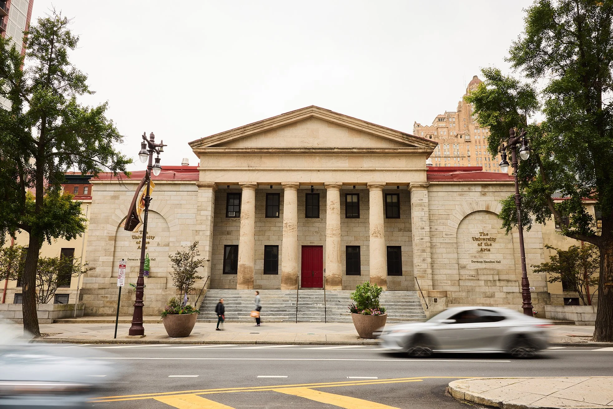 Exterior view of the historic, classically-designed stone building on Broad & Pine Streets, now called Village of Industry & Art