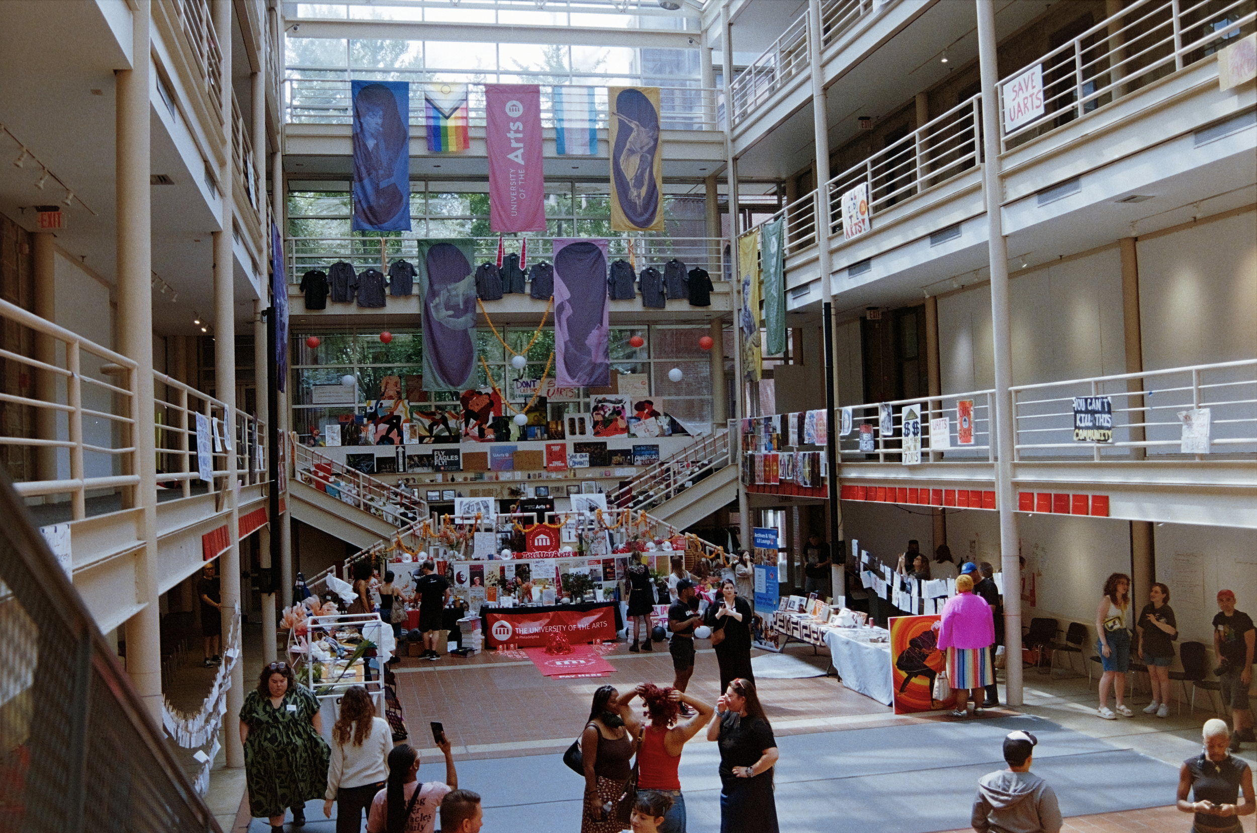 Interior atrium at Village of Industry & Art with UArts memorabilia hung everywhere on walls and balconies with visitors during the Celebration of Life event.