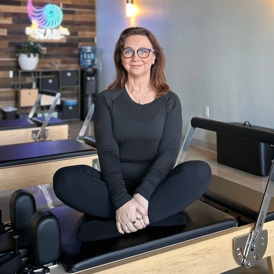 Melissa Duncan, a Gluckstadt, MS Pilates instructor, sitting on a reformer machine at Body & Soul Pilates