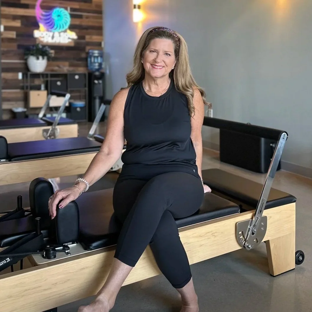 Tish Robinson, a Gluckstadt, MS Pilates instructor, sitting on a reformer machine at Body & Soul Pilates