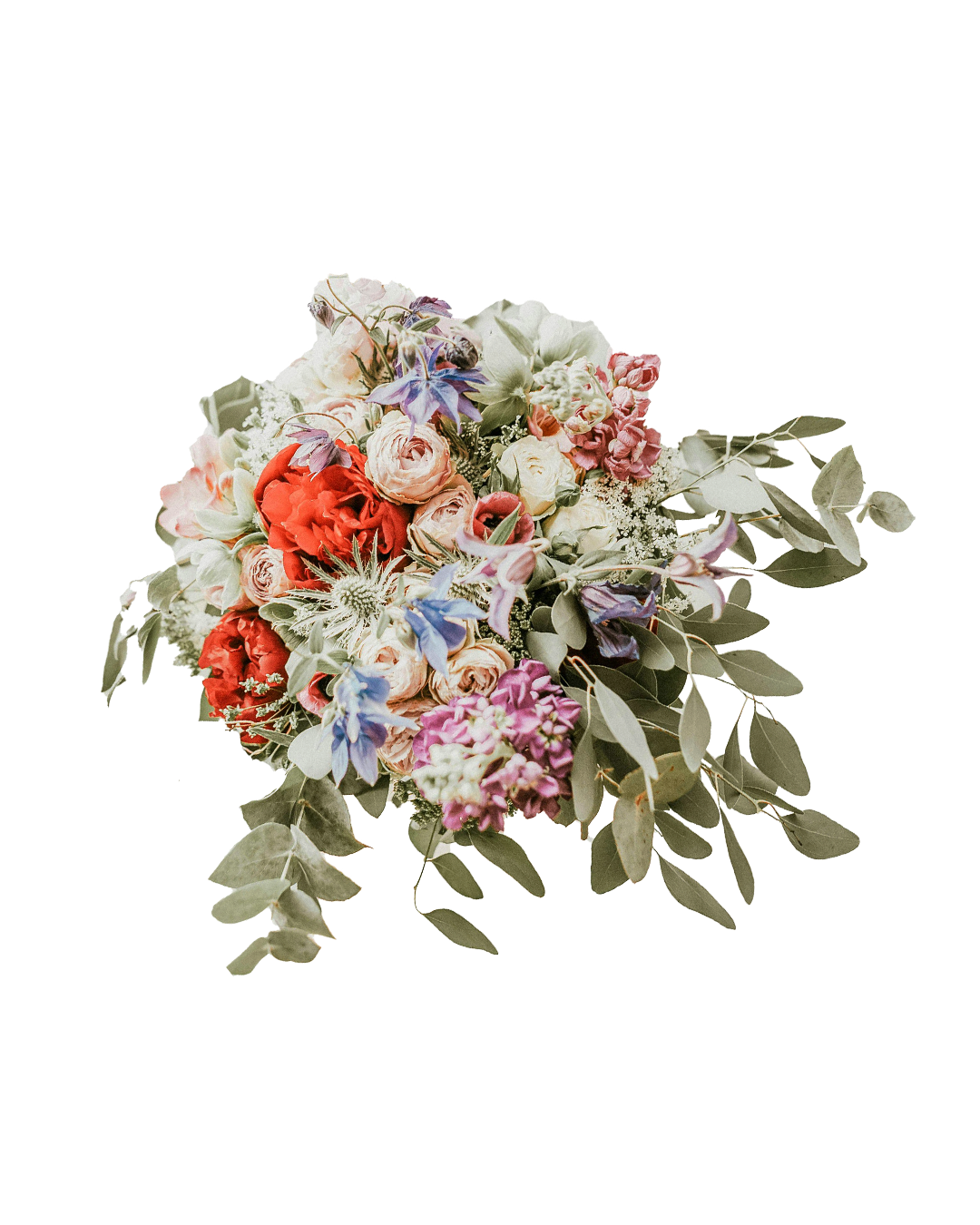 A colorful bouquet of various flowers including roses, delphiniums, and eucalyptus leaves.