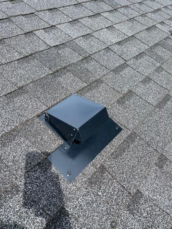 Roof vent pipe flashing on shingled roof.