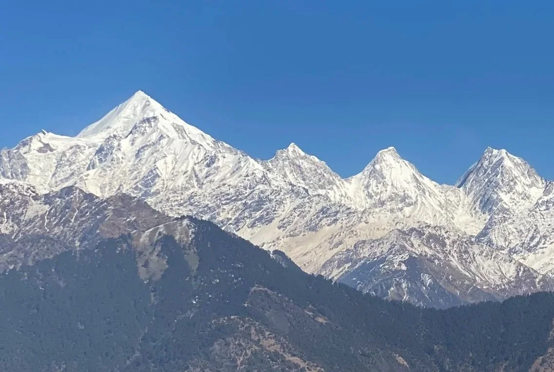 Snow-capped mountains under a clear blue sky.