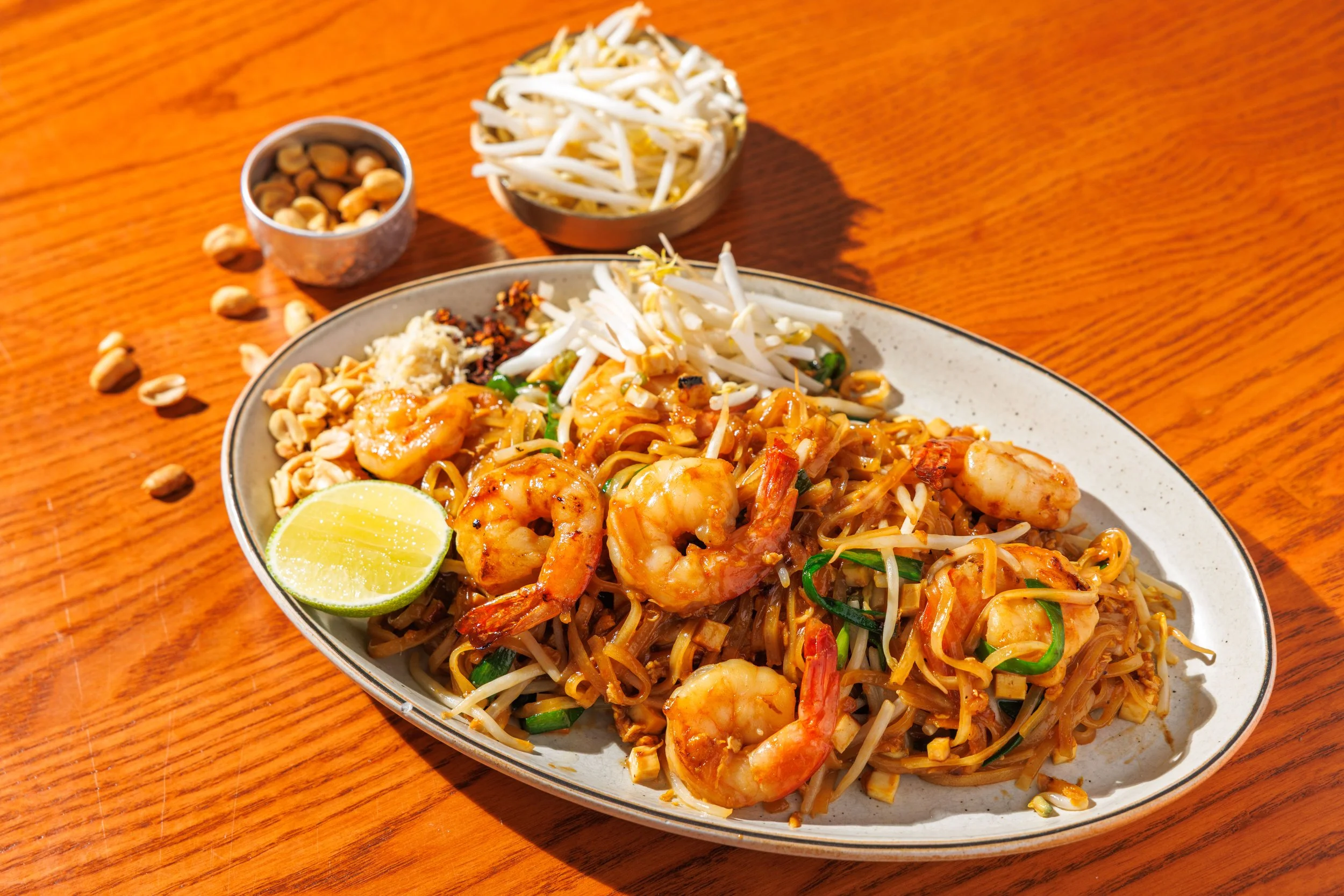 Stir-fried rice noodles with shrimp, egg, chive, bean sprouts & crushed peanut.