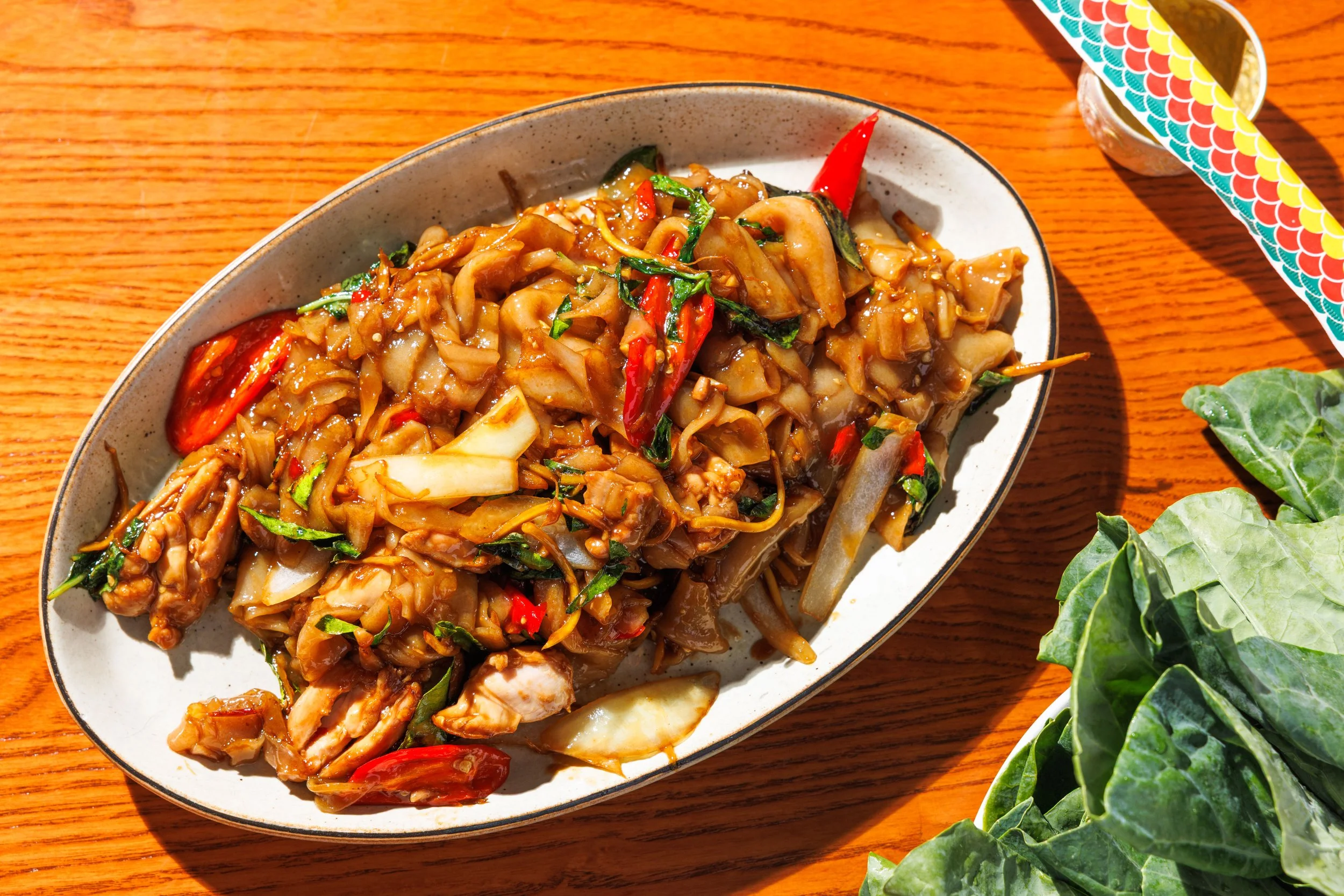 “Drunken” spicy wide rice noodles with chicken, Thai basil, chili, garlic & long red chili.