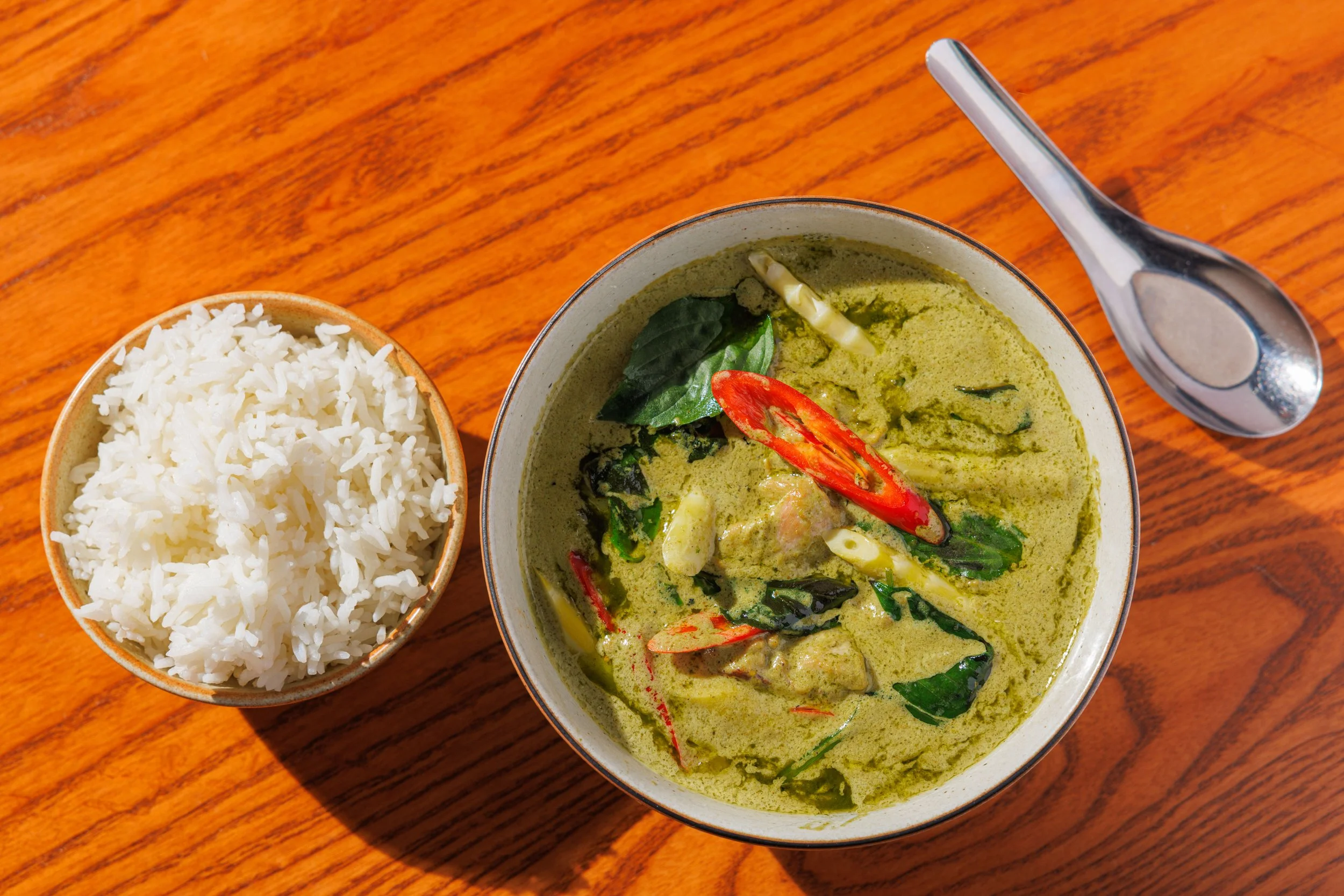 Green curry with chicken thigh, Japanese eggplant, bamboo shoot, basil & coconut milk served with rice.