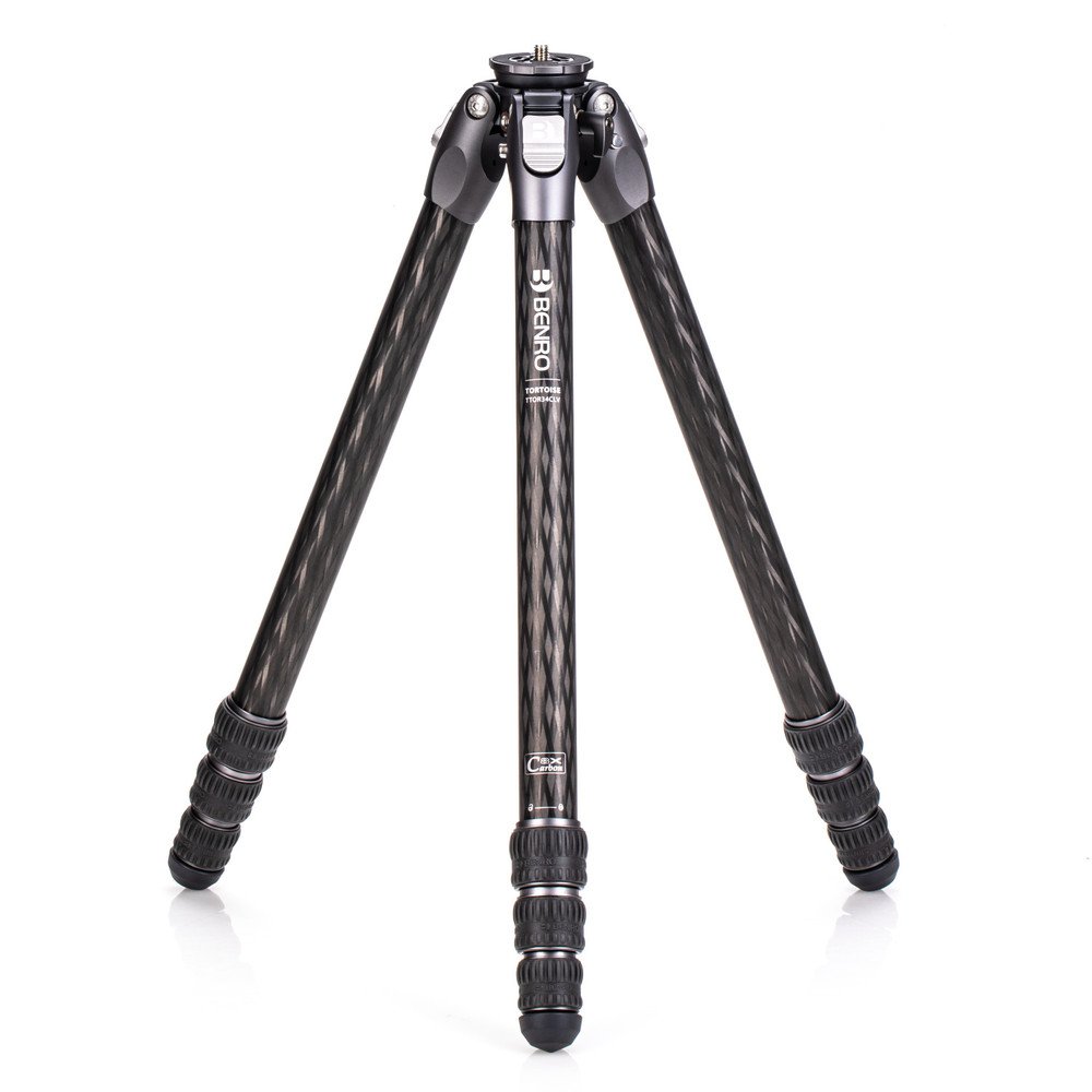 A black carbon fiber Benro tripod with three legs extended, standing on a white background.