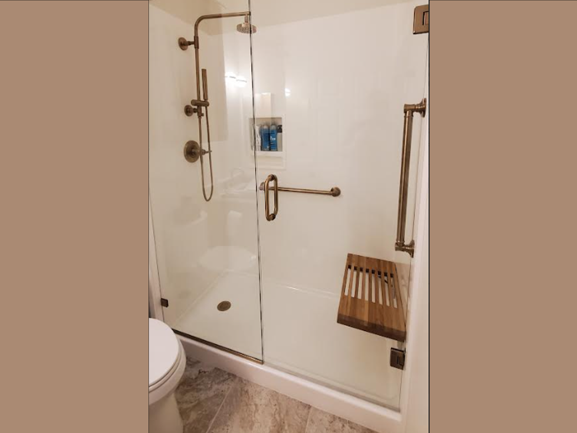 Aging-in-place shower with gold-tone fixtures in Central Texas
