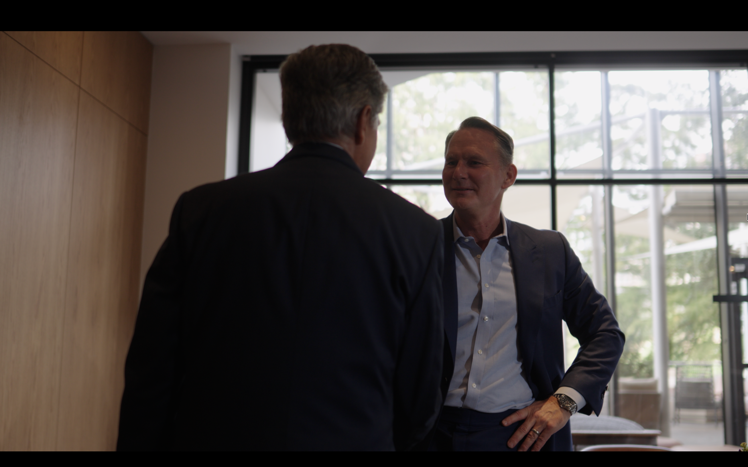 Business leaders in conversation during a CBS documentary production