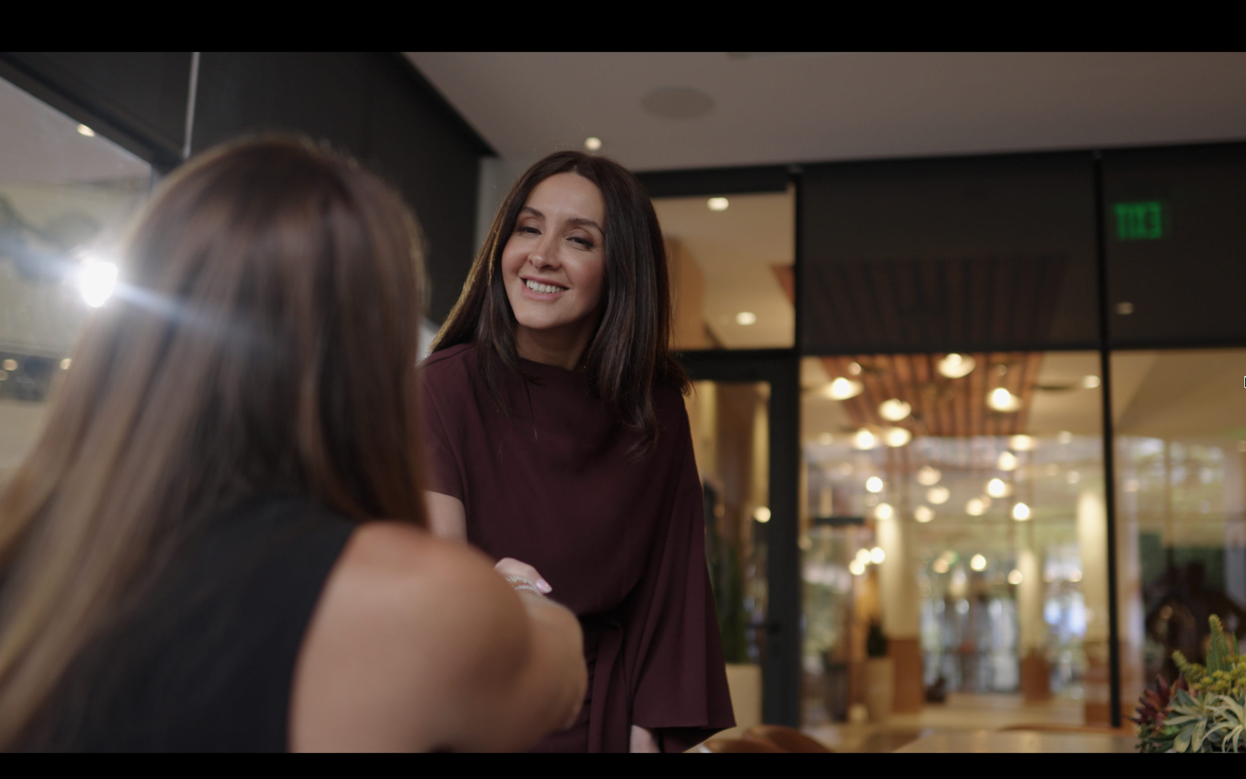 Business professionals in conversation during a corporate brand video shoot