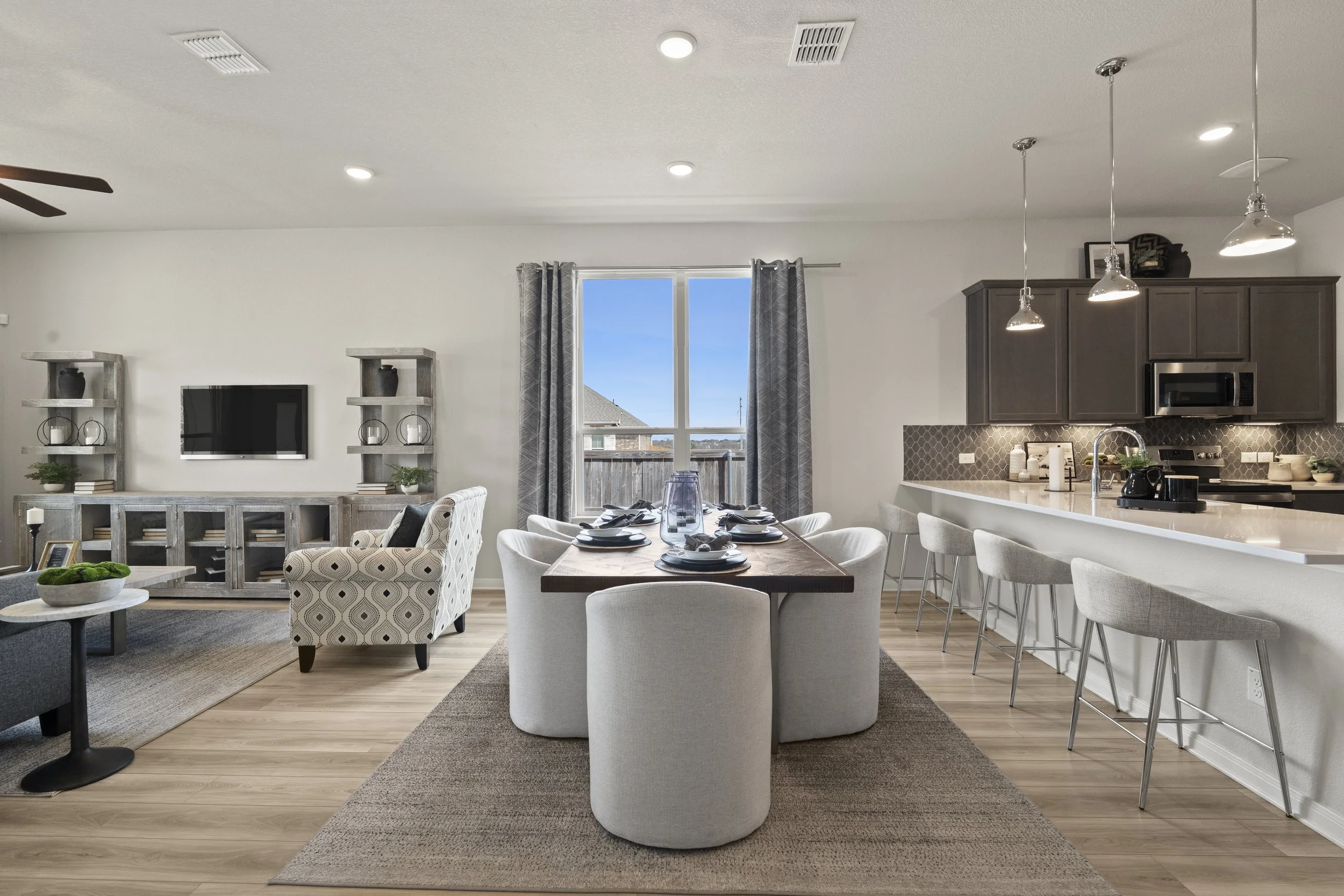 Open-concept living and dining area with a kitchen, dining table, and sitting area.