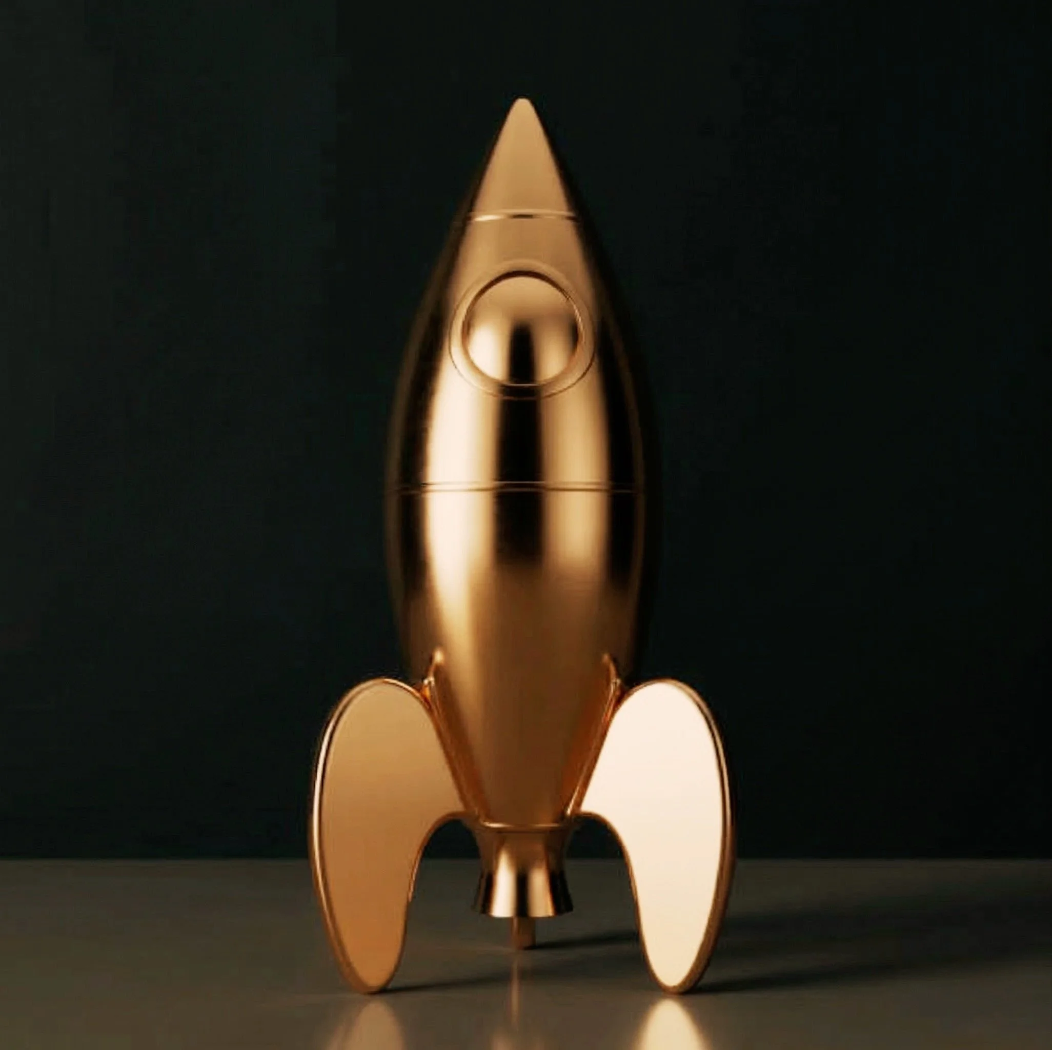 A metallic gold rocket-shaped object with a pointed nose, circular window, and curved fins, standing on a flat surface against a dark background.