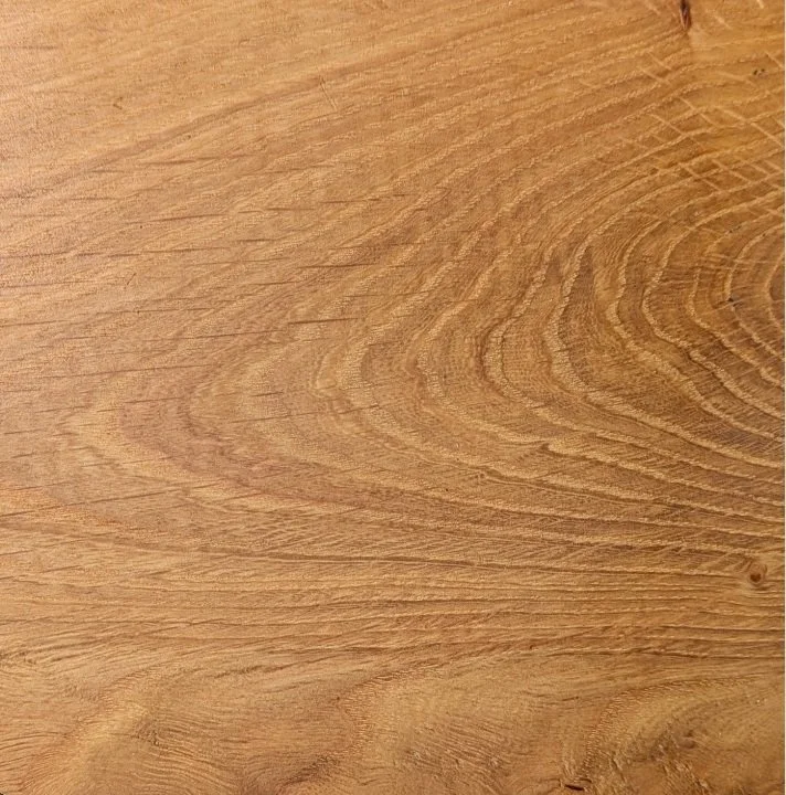 Close-up of a wooden surface with visible wood grain patterns.