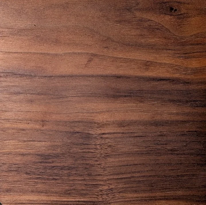 Close-up of a wooden surface with visible grain and a natural brown finish.