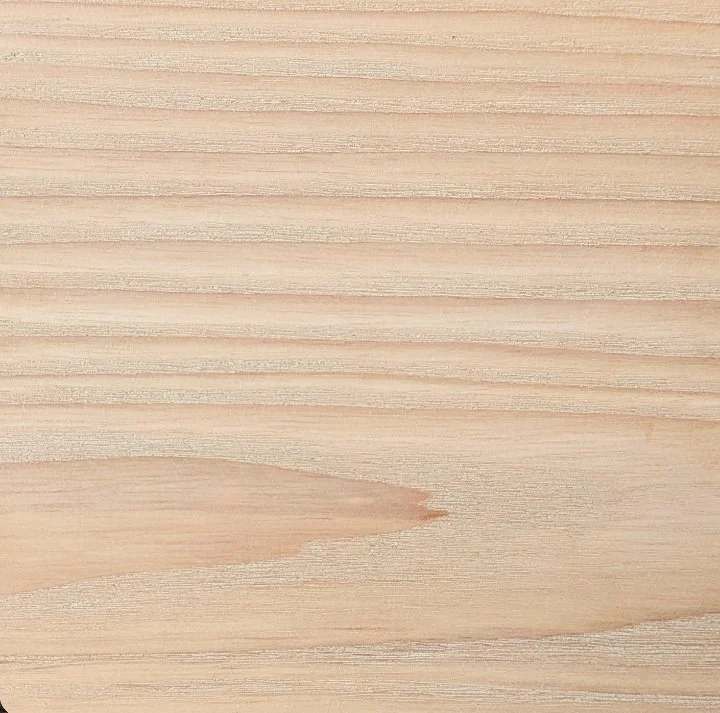 Close-up of a light-colored wooden surface with visible wood grain.