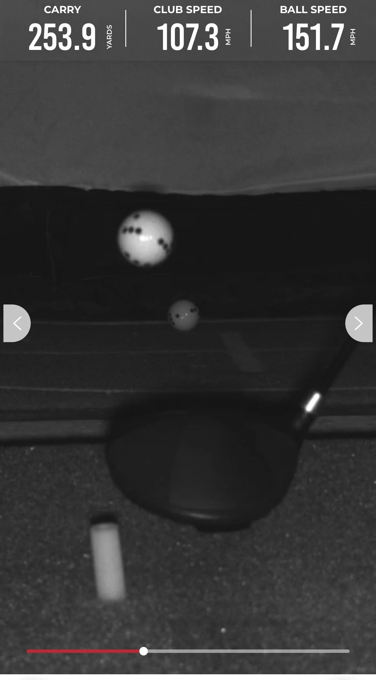 Golf ball on a tee with a digital display showing carry distance of 253.9 yards, club speed of 107.3 mph, and ball speed of 151.7 mph.