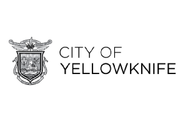 Logo of the City of Yellowknife featuring a shield with symbols and a sword, with the text 'City of Yellowknife' beside it.